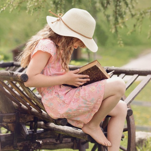 Девочка читает раскрытую книгу