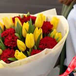 Маленькое фото 3: Букет из 17 желтых тюльпанов и 12 красных гвоздик в белой бумаге с лентой. Сервис доставки цветов AzaliaNow